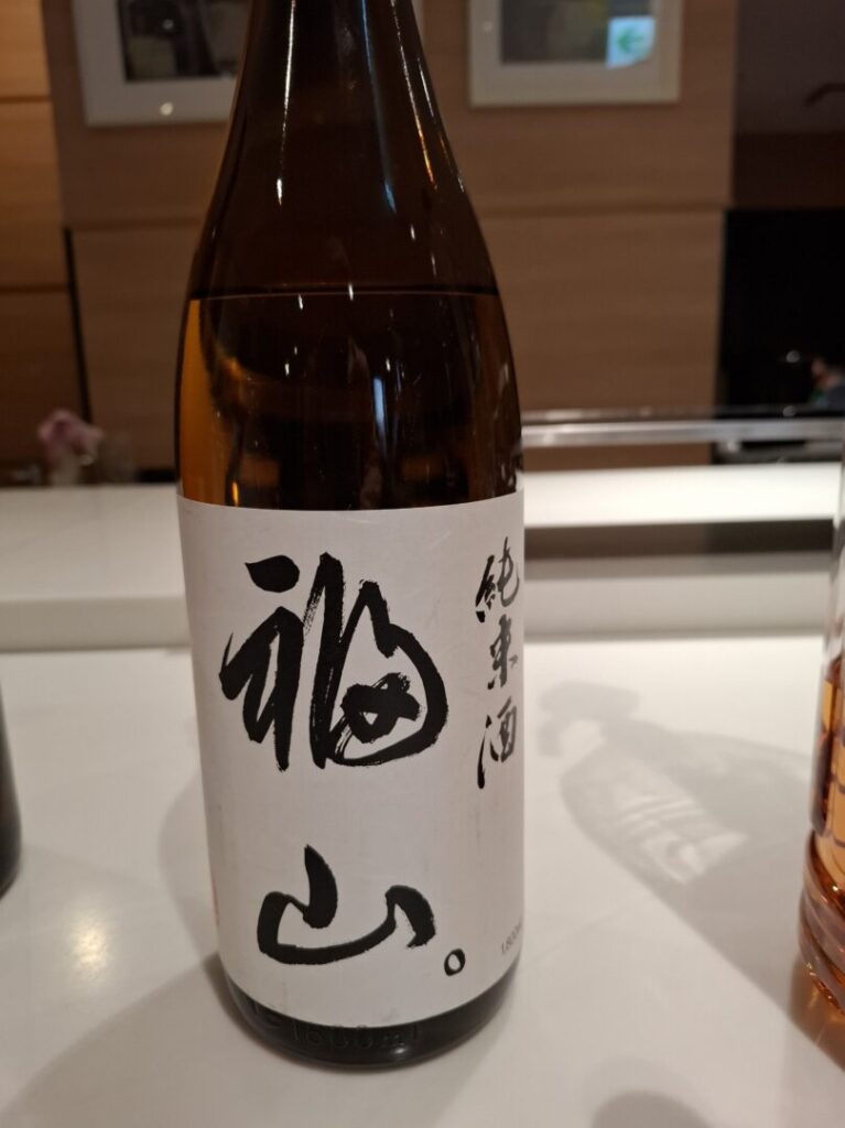 筆者が訪れた広島県福山市で宿泊したカンデオホテルズ福山でハッピーアワーで提供された日本酒福山を撮った写真